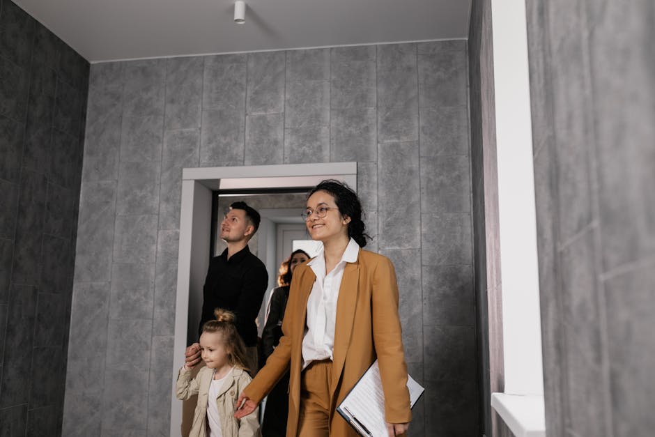 A realtor showing a family their prospective new home in a modern apartment.